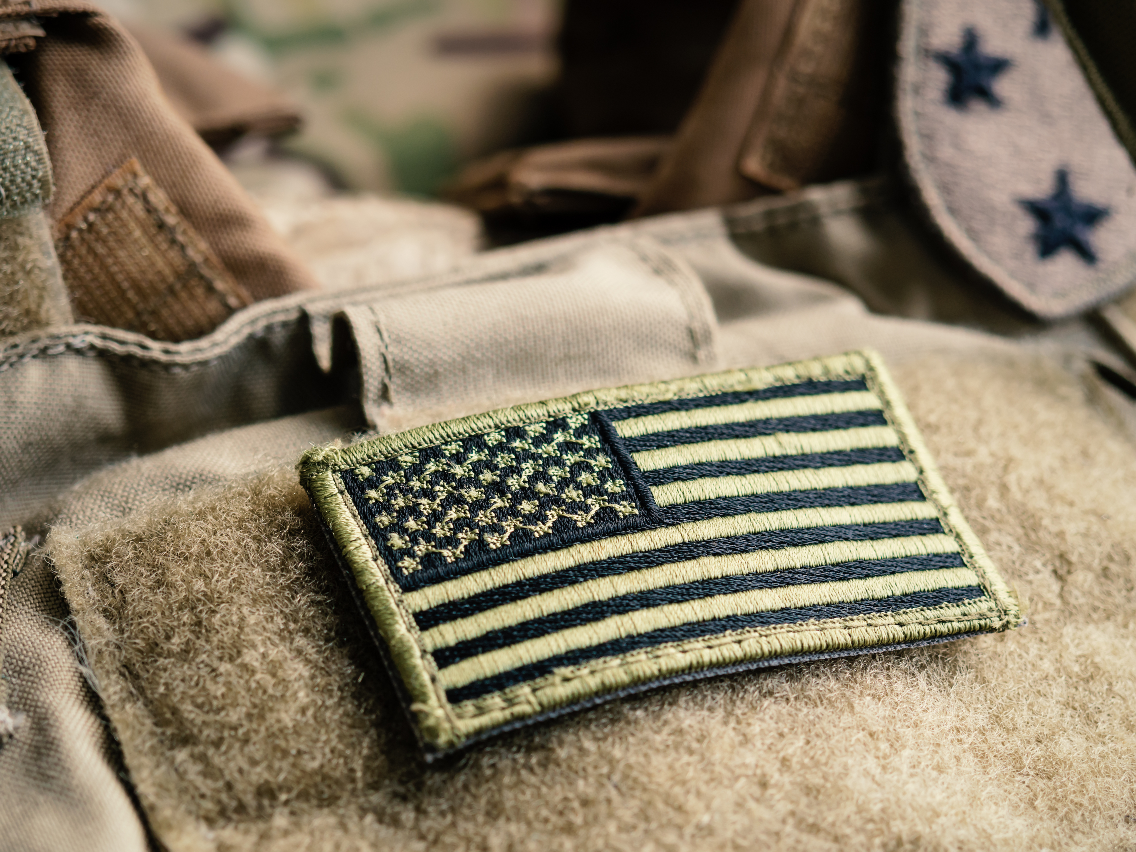 Green US flag patch on the tactical bulletproof vest Green US flag patch on the tactical bulletproof vest