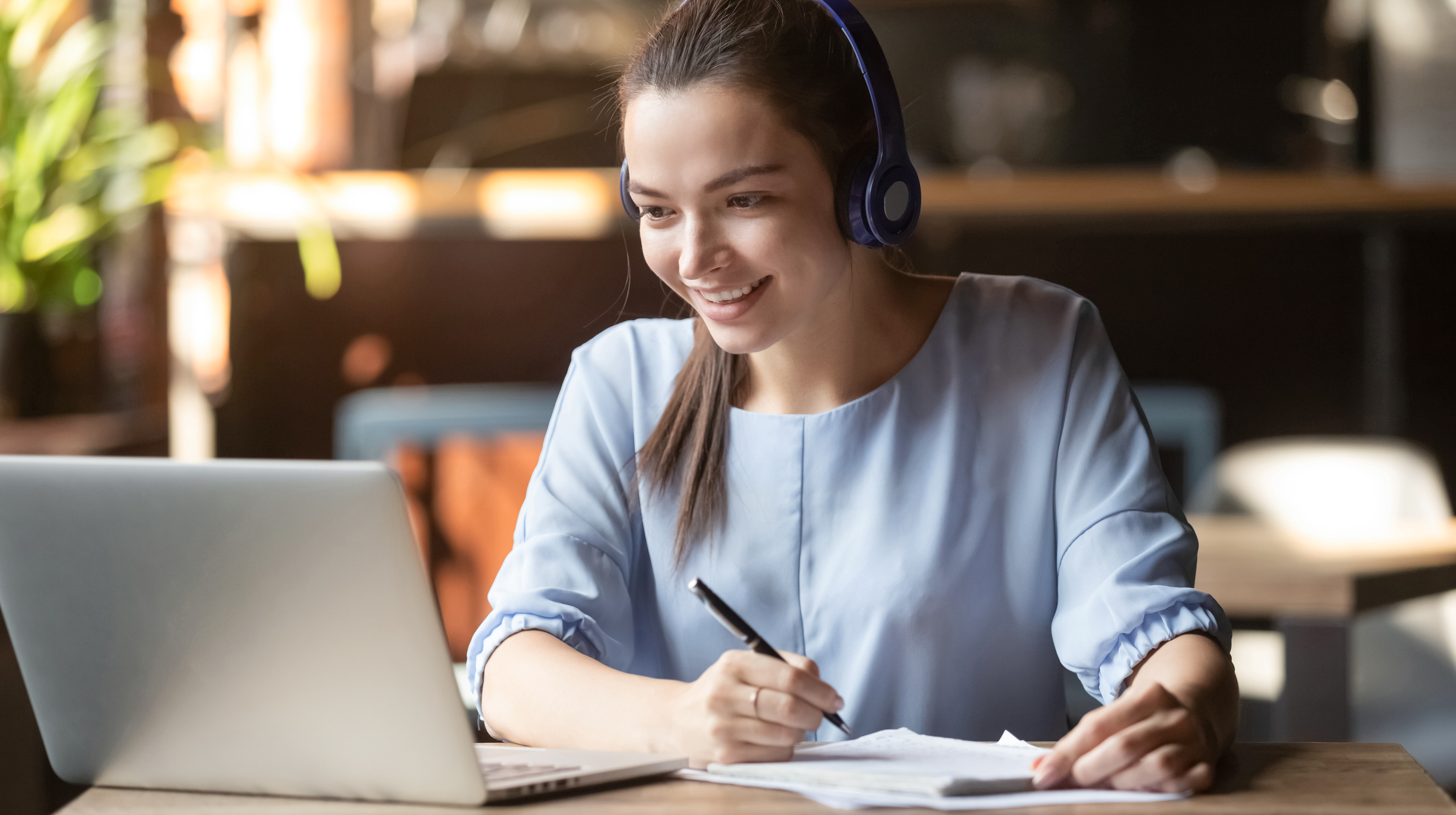 Smiling girl student wear wireless headphone study online with skype teacher Smiling girl student wear wireless headphone study online with skype teacher