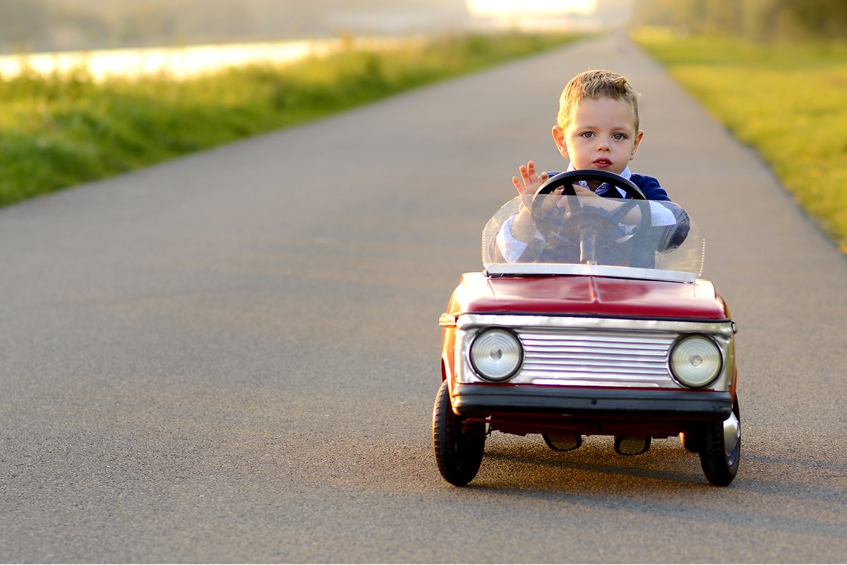 Little boy with red car