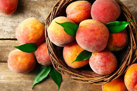 Peaches into a basket
