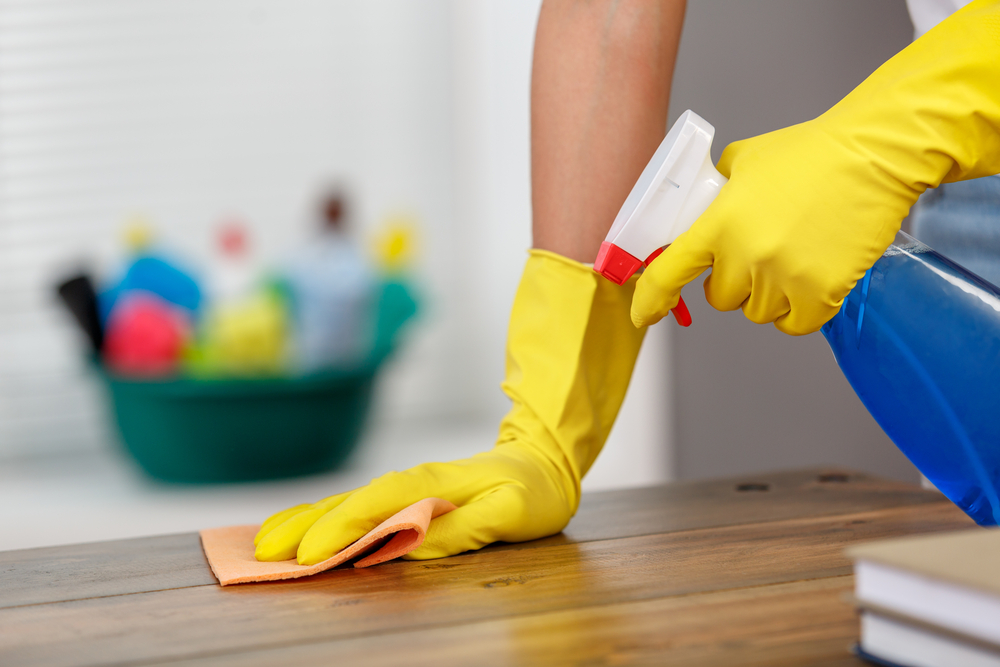 cleaning-table-with-gloves-and-sponge cleaning-table-with-gloves-and-sponge