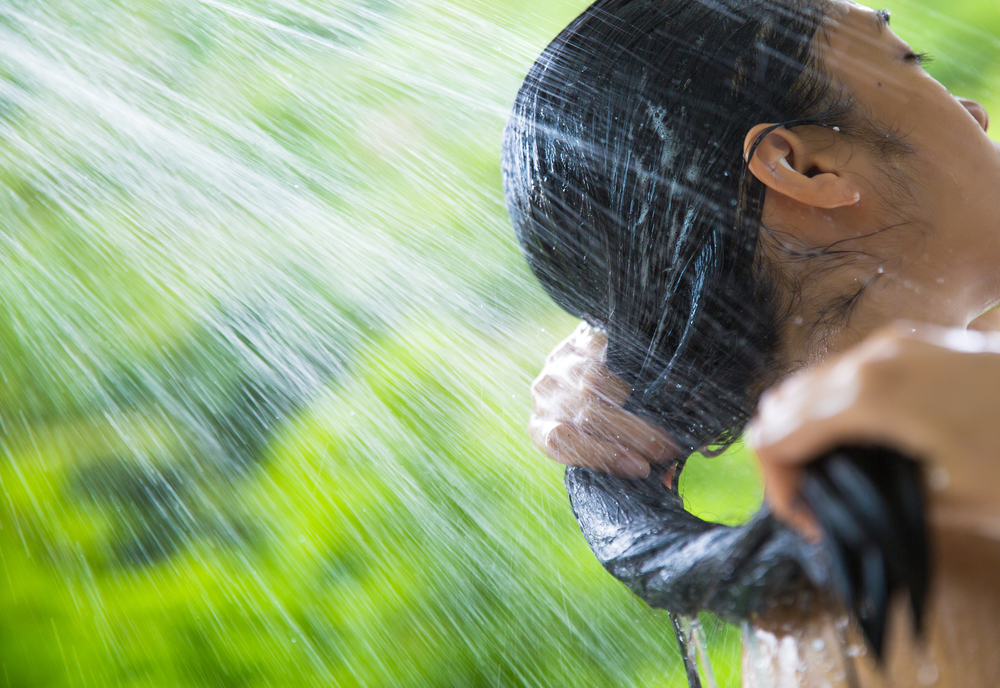 woman-shampooing-in-an-outdoor-shower woman-shampooing-in-an-outdoor-shower
