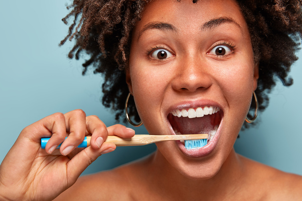 Lady brushing her teeth