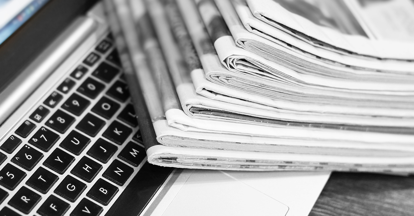 Newspapers and laptop Newspapers and laptop