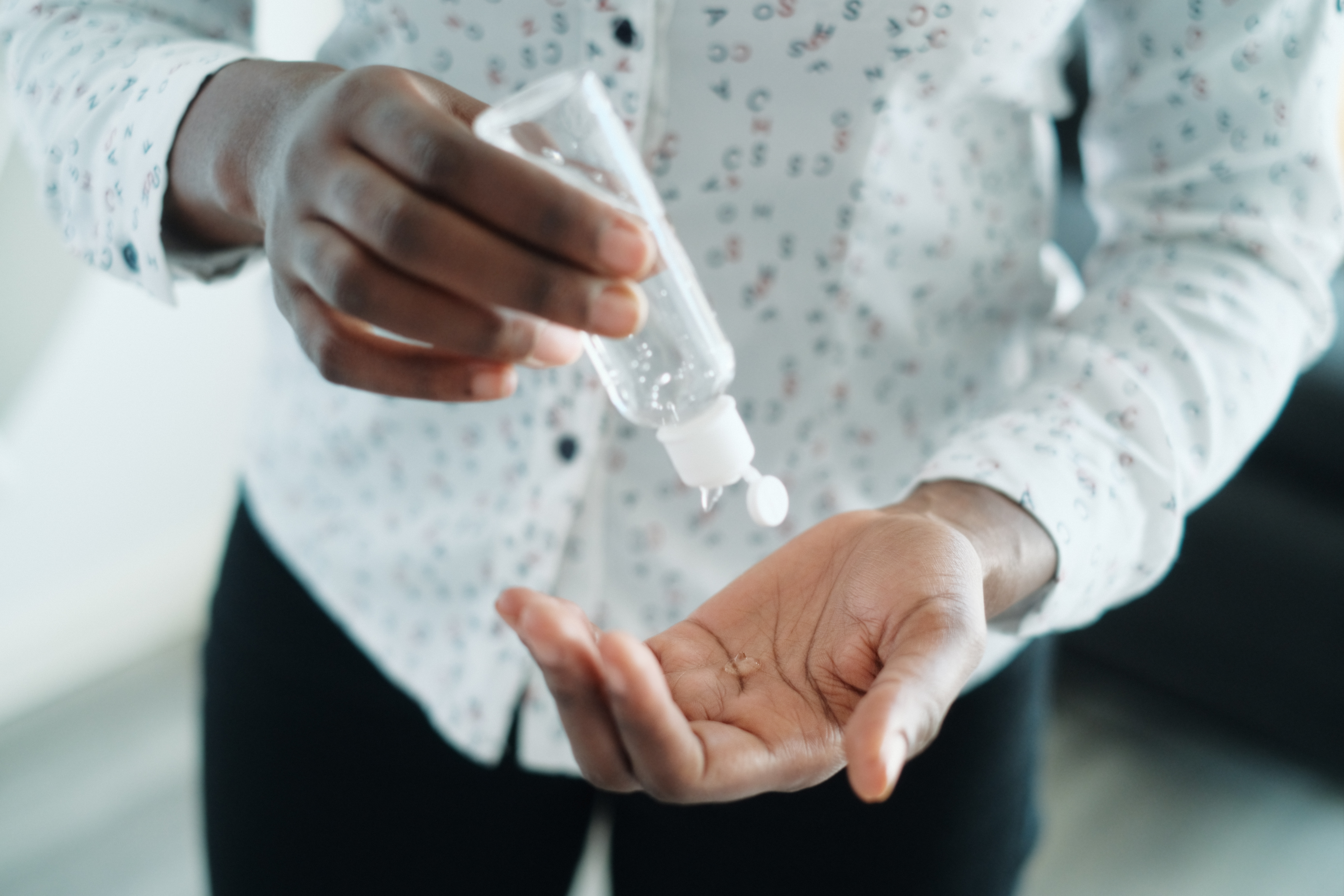 A person applying hand sanitizer gel A person applying hand sanitizer gel