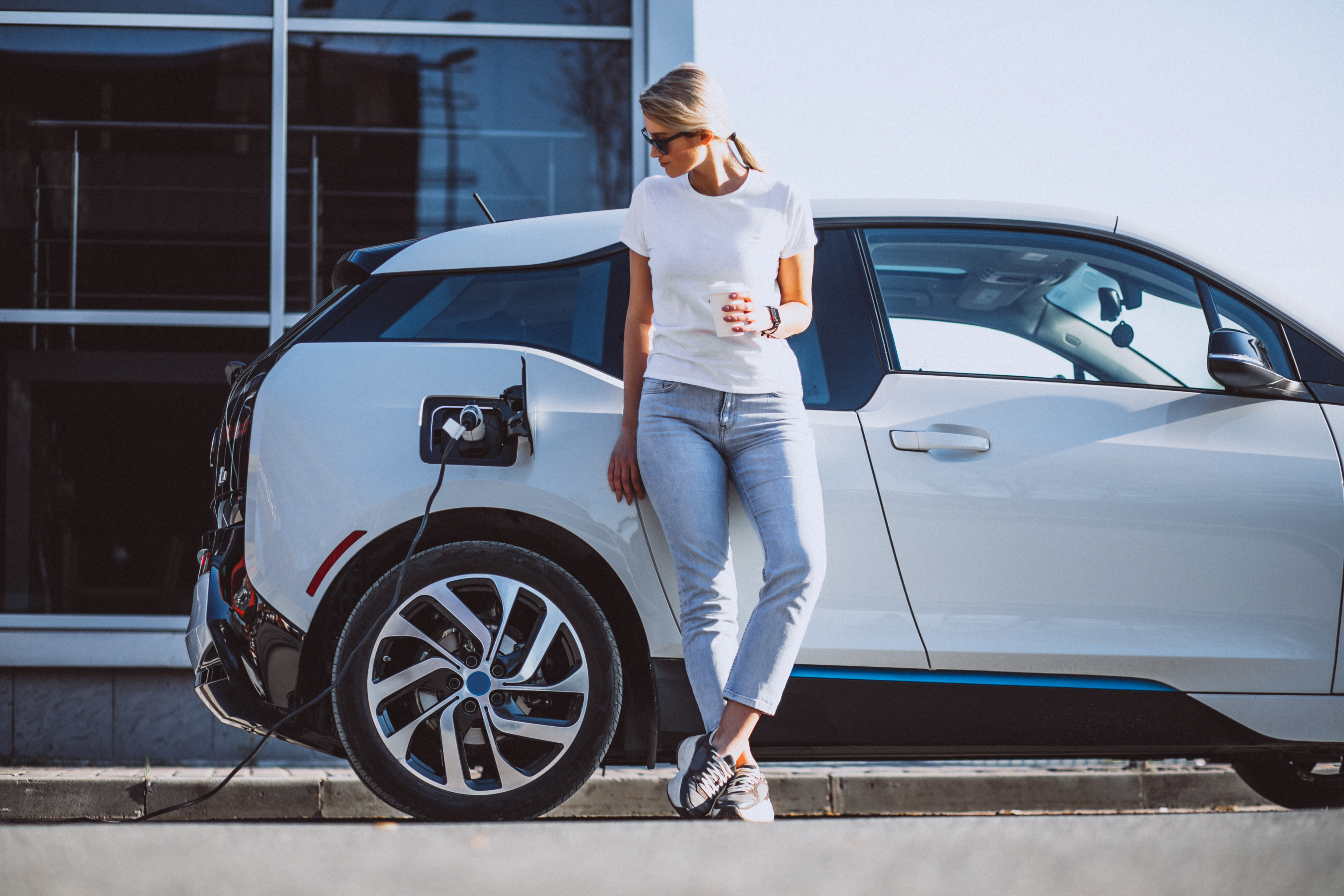 Woman standing front electric vehicle Woman standing front electric vehicle